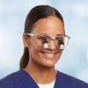 Woman wearing Enova's Ergo Elite loupes on a silver airon frame